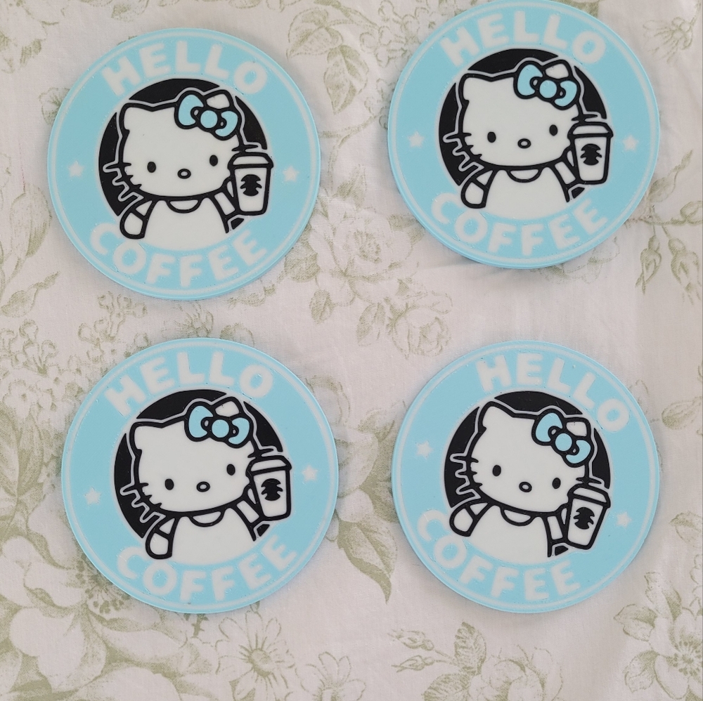Four hello kitty coasters with holder